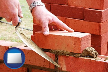 a bricklayer laying brick, building a brick wall - with Colorado icon