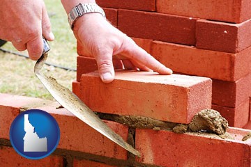 a bricklayer laying brick, building a brick wall - with Idaho icon