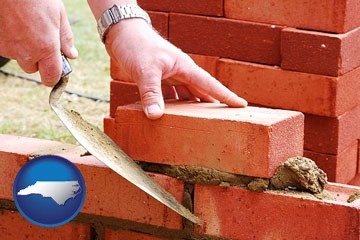 a bricklayer laying brick, building a brick wall - with North Carolina icon
